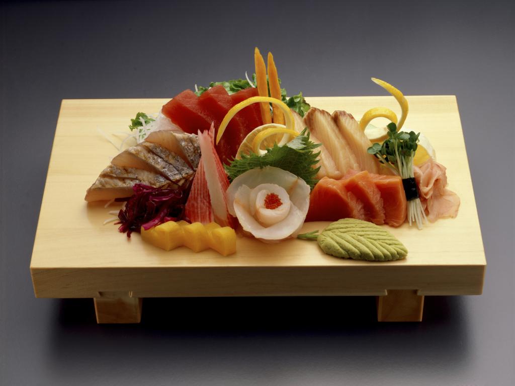 High angle of sashimi and wasabi on a cutting board