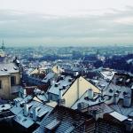 Photograph of rooftops and a cloudy sky